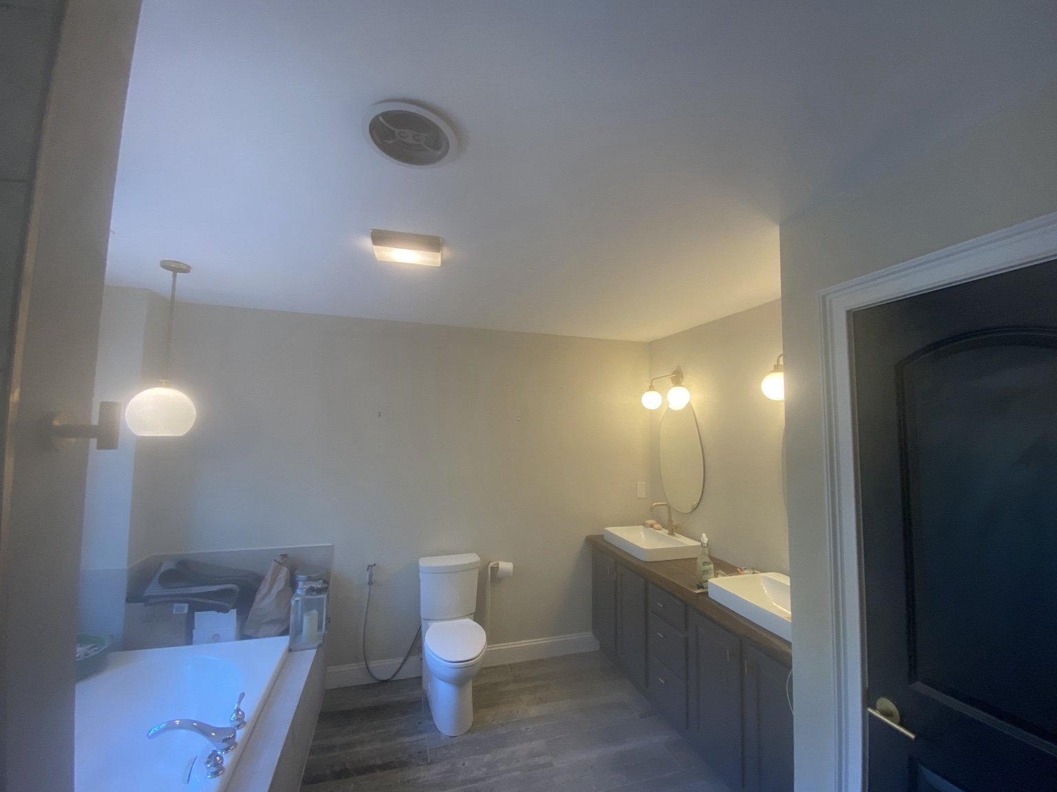 Bathroom with a freestanding tub, vanity, and tiled floor