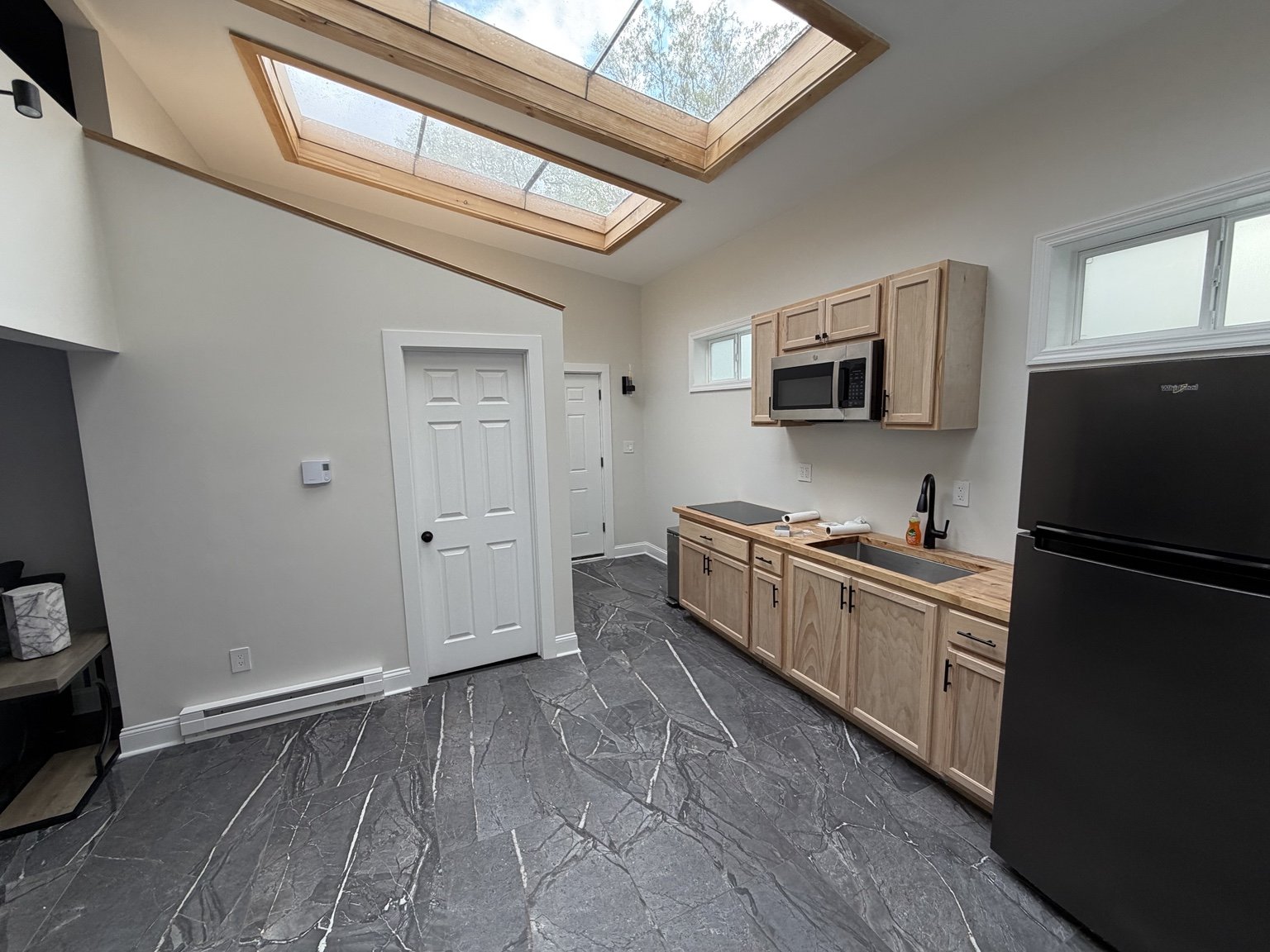 Finished kitchenette with tile flooring and skylights