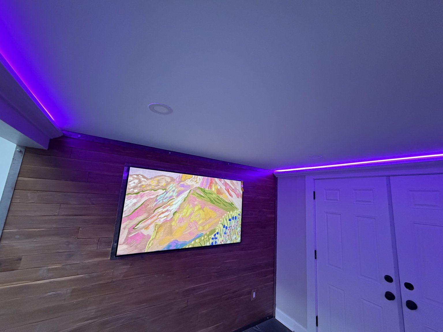 Finished room with accent lighting and feature wall