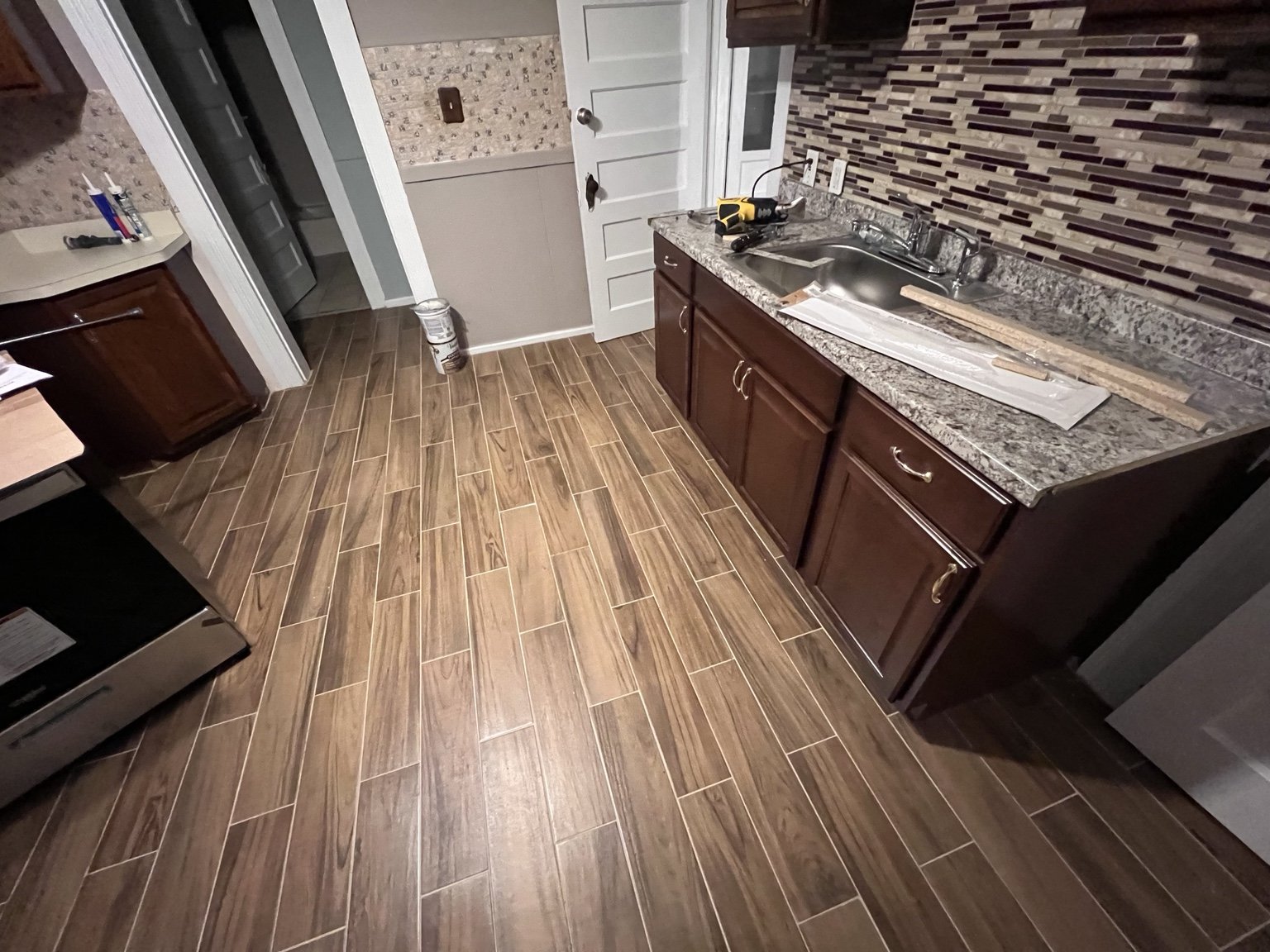 Bathroom vanity, tile flooring, and wall tile
