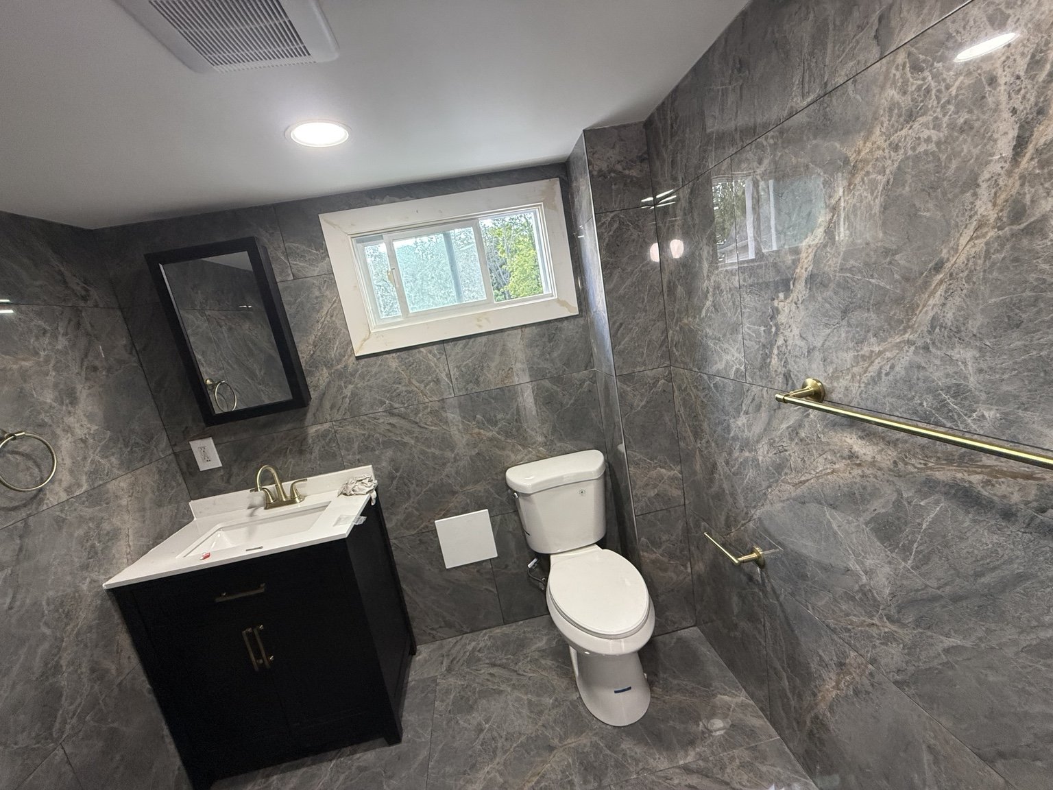 Completed bathroom with large-format wall tile